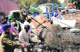 The enforcement wing of the municipal corporation carries out an anti-encroachment drive at Phase I of the Industrial Area in Chandigarh on Friday.
