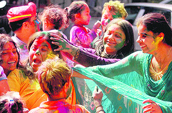 People celebrate Holi at Phase IV in Mohali on Thursday.