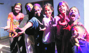 Girls celebrate Holi in Dehradun on Thursday.