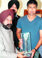 Cricketer Rahul Sharma being felicitated by GND University V-C AS Brar in Amritsar on Friday. 