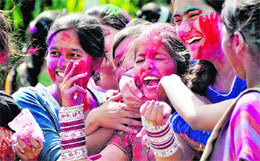Girls smear colour on each others face on Holi in Ludhiana on Thursday.