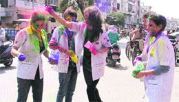 Girls play Holi at Ghumar Mandi.