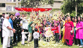 Residents of the Canal View Apartments Welfare Society celebrate Holi with flowers in Ludhiana on Thursday. 