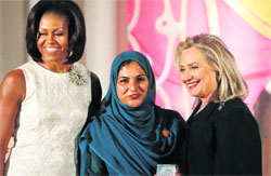 Secretary of State Hillary Rodham Clinton and US First Lady Michelle Obama present the 2012 International Women of Courage Award to Shad Begum (C) of Pakistan in Washington