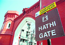 The Punjab Heritage and Tourism Promotion Board puts up a signboard near Hathi Gate in Amritsar.