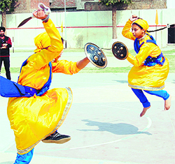 Girls perform gatka during the ongoing state-level women open gatka competition in Amritsar on Saturday.