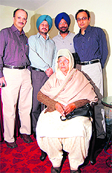 The patient poses with the doctors of the hospital in Amritsar on Saturday.