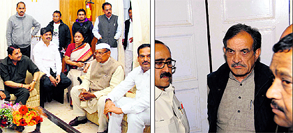 State Congress legislators wait for their turn to meet central party observer Ghulam Nabi Azad at the state guesthouse in Dehradun on Saturday; and (right) Birender Singh, Congress general secretary, with other leaders
