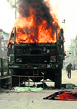 An Army vehicle set ablaze by protesters after it ran over a youth in Anantnag on Sunday.