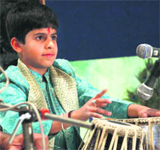 Young tabla player Vansh Arora performs during the Vasant Utsav in Jalandhar on Saturday. 