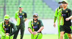 Pakistans Shahid Afridi (C) stretches with teammates during a training session at the Sher-e-Bangla Stadium in Dhaka 