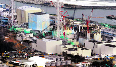The four reactor buildings of Tokyo Electric Power Cos crippled Fukushima Daiichi nuclear power plant in Fukushima prefecture are seen in this aerial view photo taken by Kyodo on Sunday, the day marking the first anniversary of the earthquake and tsunami that killed thousands and set off a nuclear crisis. 