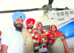 The groom, who descended at the venue for his wedding in a helicopter, along with his bride at Chappar Chiri on Sunday.
