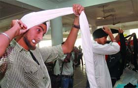 Members of the Sikh community take part in a turban-tying competition to mark Hola Mohalla in east Delhi on Sunday