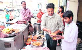 Fakir Chands son Rajesh serves a delicious chat to customers at his 64-year-old golgappa joint in Jalandhar
