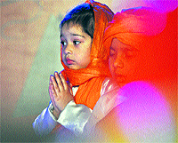 Kids perform a prayer while celebrating Grand Parents Day at Mothers Pride School in Ludhiana