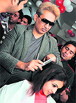 Jawed Habib styles hair for a customer at his newly launched salon