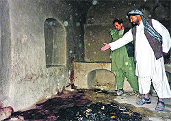 A villager points to the spot where a family was allegedly shot by a US soldier in Kandahar
