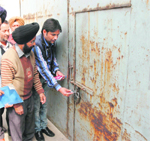 Sushant Bhatia, superintendent, House Tax, MC, seals a factory in Amritsar on Monday. 