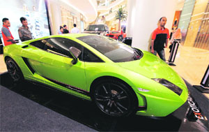 Visitors look at a Lamborghini luxury sports car on display at a shopping mall in Jakarta. Indonesia's economic revival is set to produce the fastest growing ranks of millionaires in Asia as the country enjoys a sweet spot of political stability, strong demand for its plentiful commodities and renewed investor interest. 