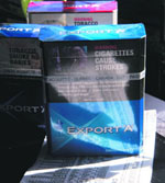 Cigarette packs sit in a store in Montral. Canada's three main tobacco companies are set to do battle in a Qubec court on Monday in a C $27 billion tobacco lawsuit, the largest civil case in Canadian history