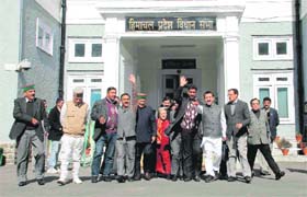 Congress MLAs walk out of the Vidhan Sabha on the second day of the Budget session in Shimla on Monday