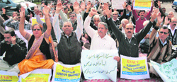 Kashmiri Pandits stage a protest in support of the passage of Temples Bill in Jammu