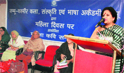 Savita Bakshi, additional secretary of the Academy of Art, Culture and Languages, addresses a gathering during a mushaira at KL Sehgal Hall in Jammu 