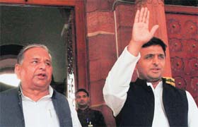 Samajwadi Party leaders Mulayam Singh Yadav and Akhilesh Yadav outside Parliament in New Delhi on Monday