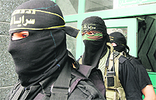 Islamic Jihad militants arrive for a press conference in Gaza City on Monday. 