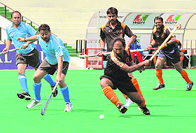 Players vie for the ball during the All-India Audit-General Hockey Championship at the Sector-42 hockey stadium in Chandigarh on Monday.