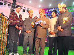 Chief Minister PK Dhumal releases a book by Dr Rajan Katoch in Palampur.