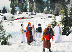 Tourists enjoy snowfall near the Solang valley 