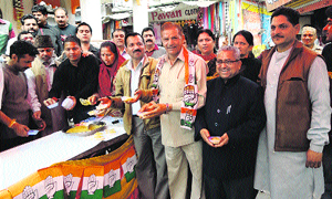 Congress supporters distribute sweets in Reasi on the selection of Jugal Kishore Sharma as party candidate for the Legislative Council election.