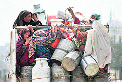 Gujjar women go to sell milk in a vehicle on the outskirts of Jammu