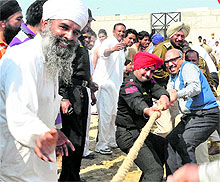 Punjab DGP (Jails) Shashi Kant (in blue sweater) takes part in tug-of-war with inmates of the Modern Jail in Kapurthala on Tuesday