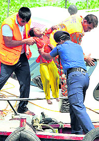 Rescue workers recover the body of a drowned child after a ferry carrying more than 250 people sank in river Meghna after colliding with a barge on Tuesday. At least 35 passengers drowned and scores of bodies are feared trapped