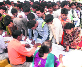 Job seekers await their turn for registration at a job fair in Faridabad on Wednesday. 