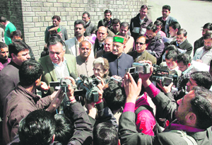 Congress MLAs talk to mediapersons after staging a walkout from the Vidhan Sabha in Shimla on Wednesday.