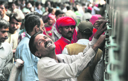 How will I Coop up? A migrant at the Ludhiana railway station seems to be cursing the hike in rail fares. 
