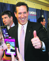 Republican US presidential candidate Rick Santorum gives the thumbs-up to supporters after speaking at his primary election night rally in Louisiana