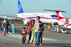Visitors look at aircraft parked on the tarmac at the India Aviation 2012 show at Begumpet airport in Hyderabad
