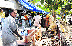 Employees of the municipal corporation remove encroachments from the furniture market at Sector 34 in Chandigarh on Thursday
