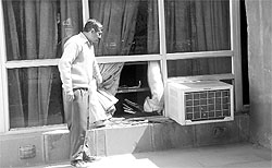 A man shows a broken window of the library at Silvi Park in Phase X of Mohali