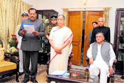 Governor Margaret Alva administers the oath of office to Shailendra Mohan Singhal, a Congress legislator, as pro tem Speaker in Dehradun on Thursday. Chief Minister Vijay Bahuguna is also seen in the picture.