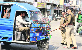 Traffic police personnel intercept an overloaded Vikram on the Rishikul intersection in Haridwar on Thursday.