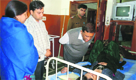 A Health Department team collects information from a patient during a raid on a nursing home in Karnal on Wednesday night.