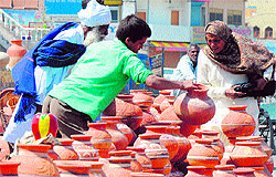 As summer approaches, a woman selects an earthen pot in Karnal