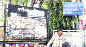 The rate board of parking charges at the entrance to the District Administrative Complex has been covered by posters and advertisements leading to inconvenience to visitors