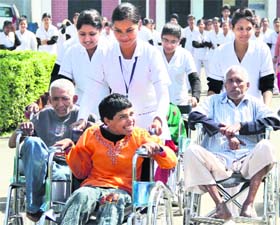 Students of St Soldier Nursing Institute spend time with differently abled at the Pingla Ghar in Jalandhar on Thursday